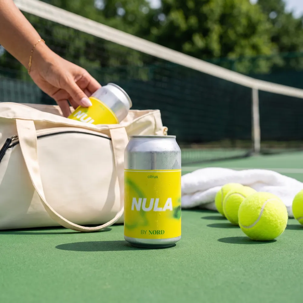 NULA can in a tennis bag, AI lifestyle photo made with ProductAI