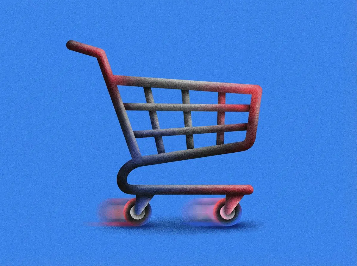 Shopping cart with motion-blurred wheels on blue background
