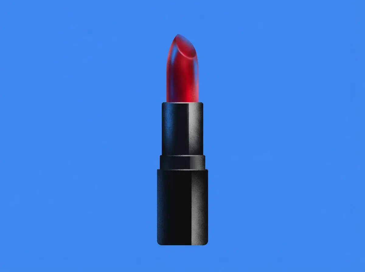 Red lipstick in a black tube on blue background