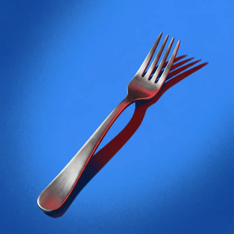 Metal fork casting a red shadow on blue background